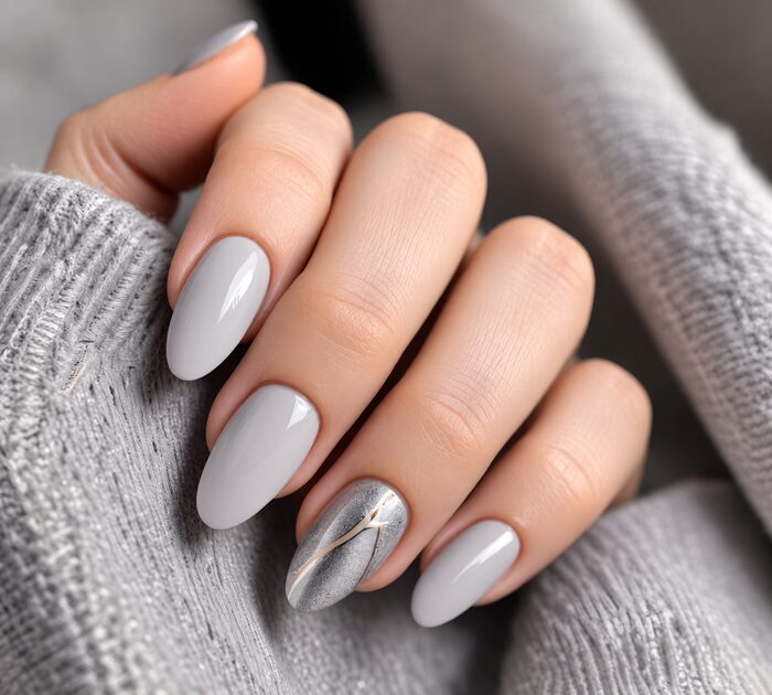 Soft grey almond nails with a silver marble accent nail