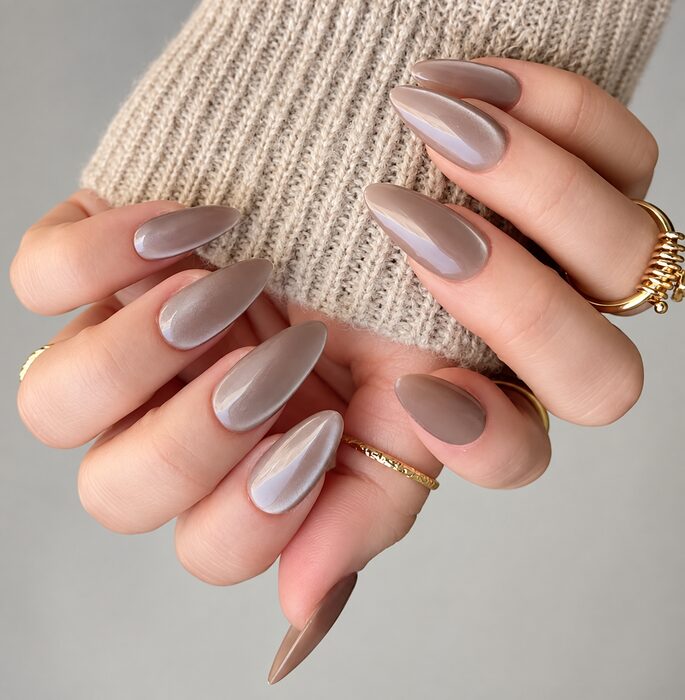 Taupe chrome on long almond nails with gold rings