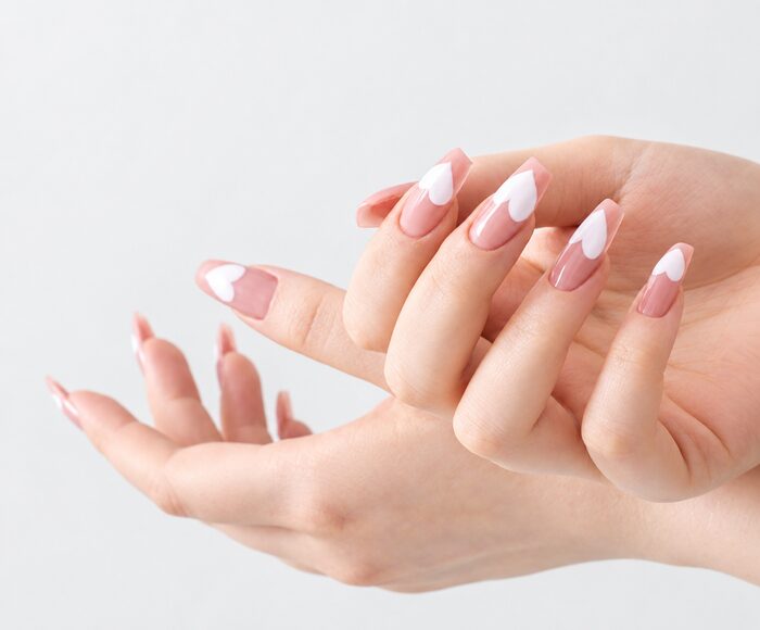 Nude almond nails with crisp white chevron French tips